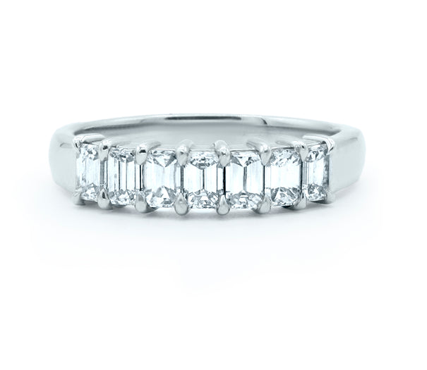 Seven-stone emerald-cut diamond wedding ring in gold, featuring a sleek band and radiant diamonds for timeless elegance
